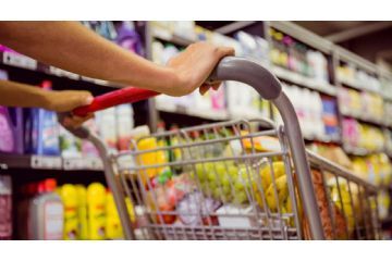 supermercato con generi alimentari e carrello spesa con un due mani che spingono